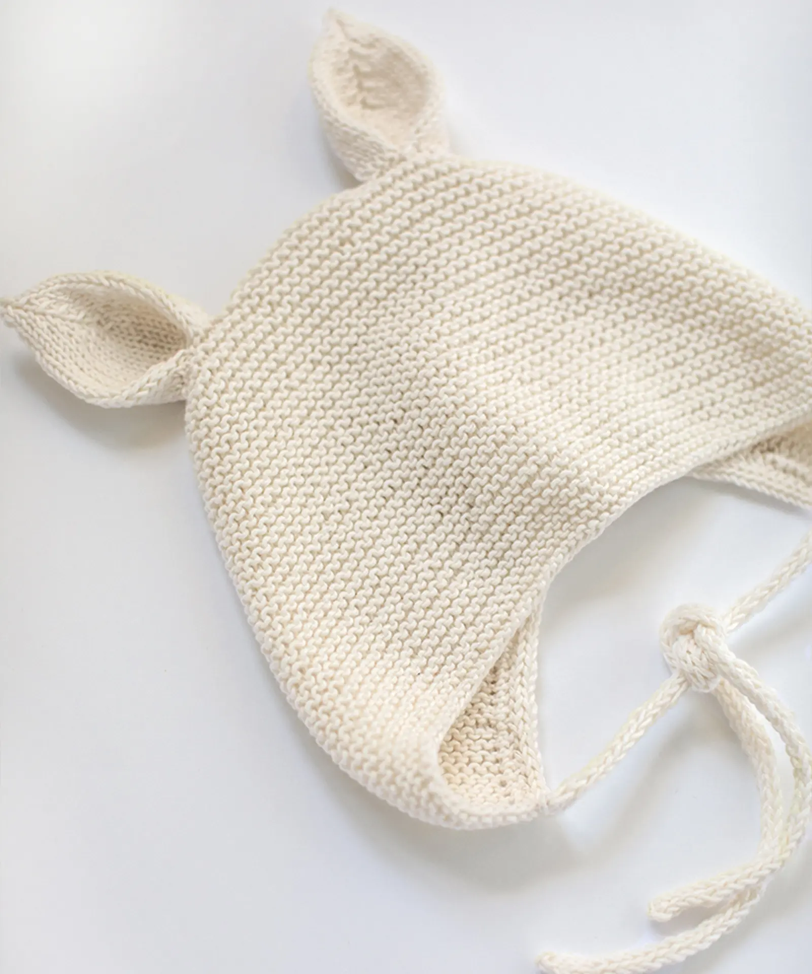 Top view of knitted hat with animal ears in white color